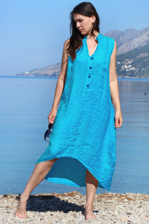 Airy linen summer women's dress for lovers of natural nature style. one color design midi length with extended back